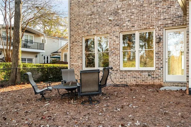 a view of a house with backyard and sitting area