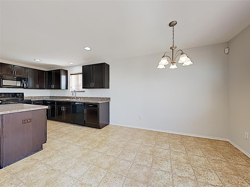 1620 Gayla Creek Drive Little Elm, TX 75068 - Photo 6 of 13 a large kitchen with stainless steel appliances granite countertop a sink a stove top oven a counter space and cabinets