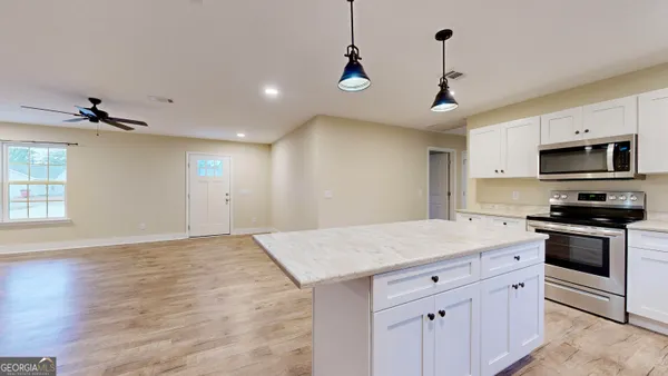 a kitchen with a stove a sink and a refrigerator