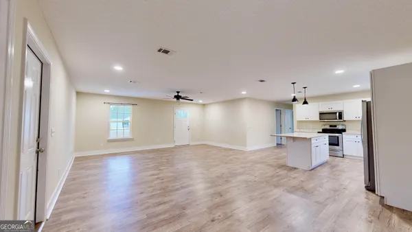a view of a kitchen with a sink and a refrigerator