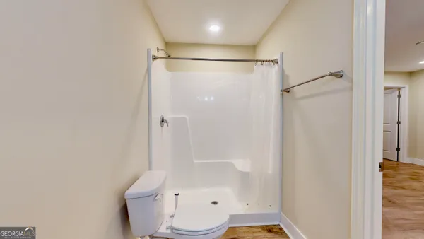 a bathroom with a shower and a toilet