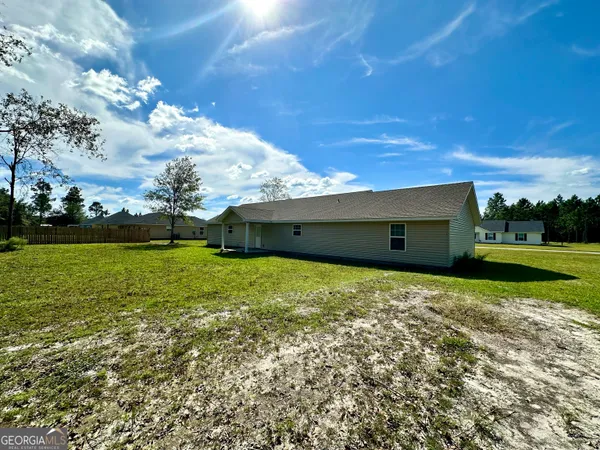 a backyard of a house with lots of green space