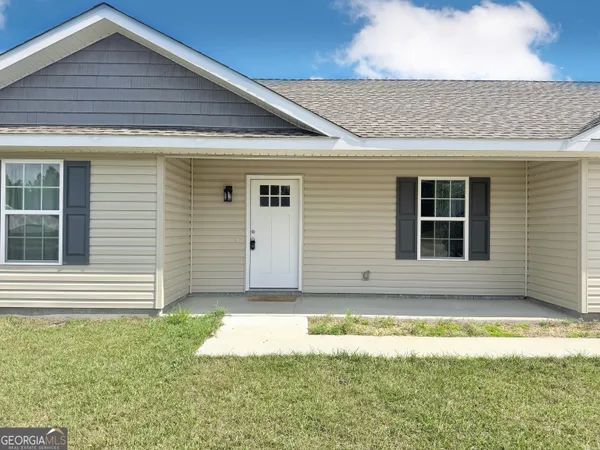 a front view of a house with a yard