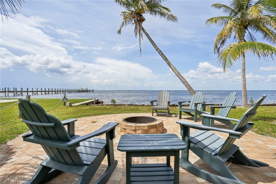 8335 Main Street Bokeelia, FL 33922 - Photo 43 of 47 an outdoor sitting area with furniture and wooden floor