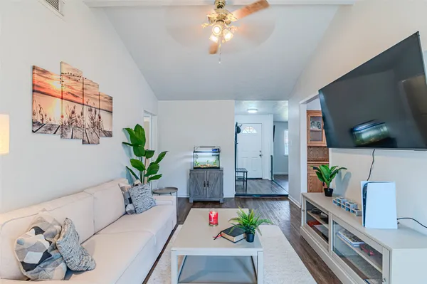 a living room with furniture and a flat screen tv