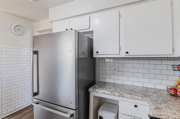 a kitchen with a refrigerator and sink