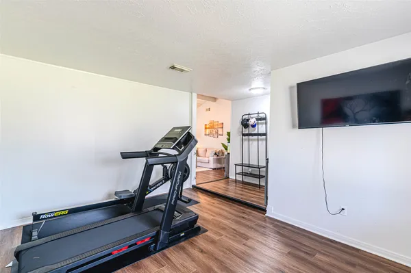 a view of a livingroom with furniture and a flat screen tv