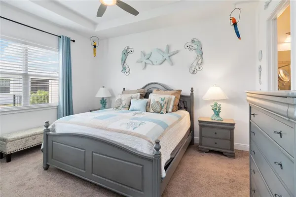 a bedroom with a bed and a window dresser