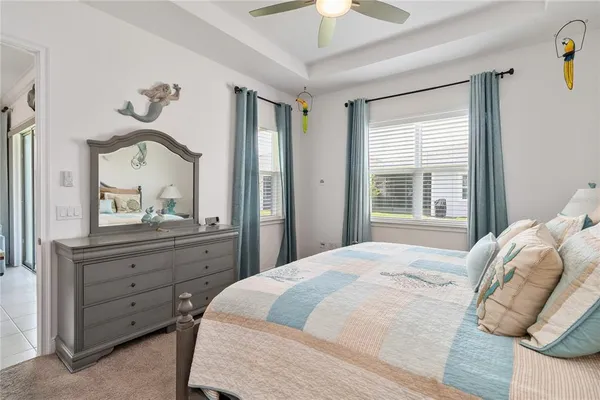 a bedroom with a bed and a mirror on dresser