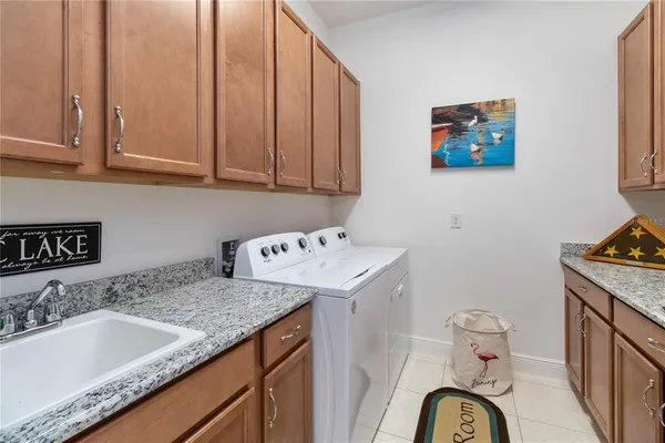 a utility room with a sink a washer and dryer