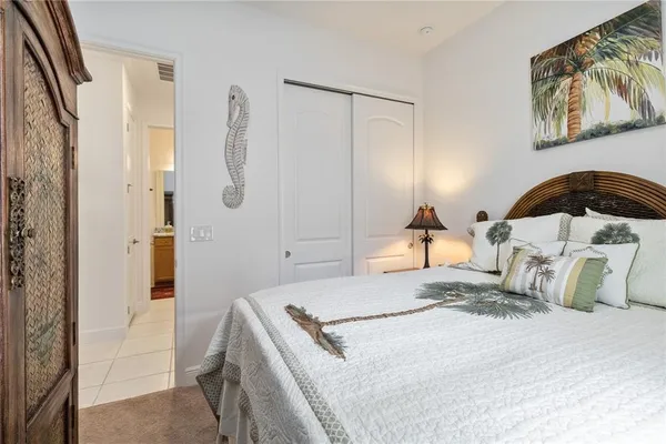 a bedroom with a bed and a mirror