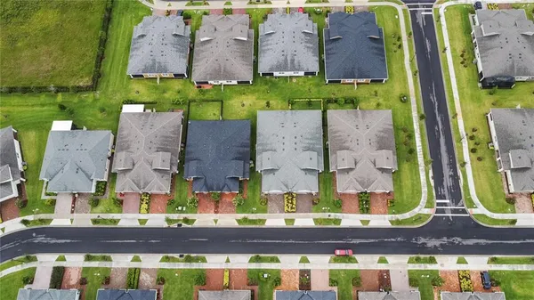 an aerial view of multiple houses with yard