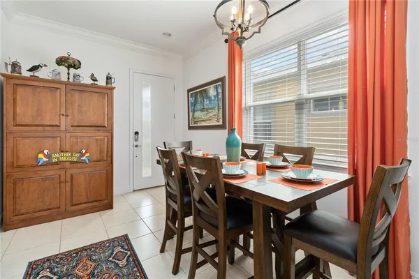 a view of a dining room with furniture and chandelier