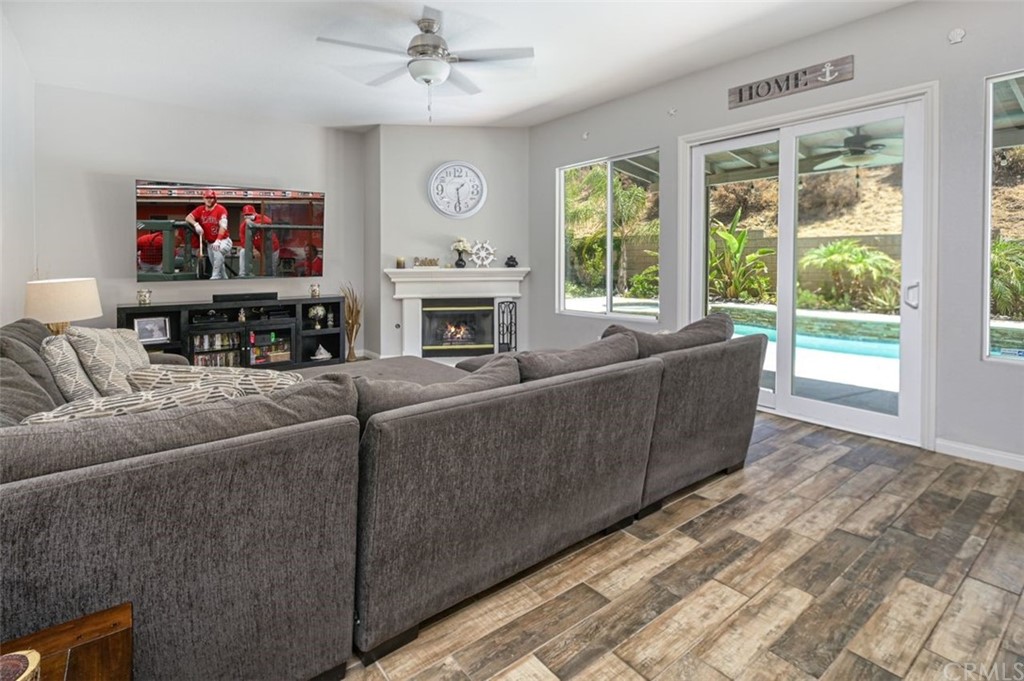 33915 Pinehurst Drive Yucaipa, CA 92399 - Photo 12 of 33 a living room with furniture a large window and a fireplace