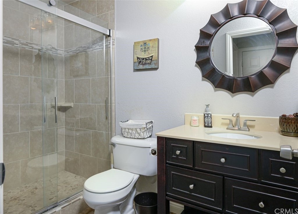 33915 Pinehurst Drive Yucaipa, CA 92399 - Photo 15 of 33 a bathroom with a toilet a sink and mirror
