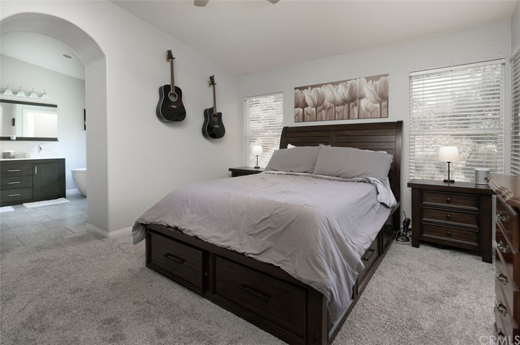 33915 Pinehurst Drive Yucaipa, CA 92399 - Photo 18 of 33 a bedroom with a bed and a painting on the wall