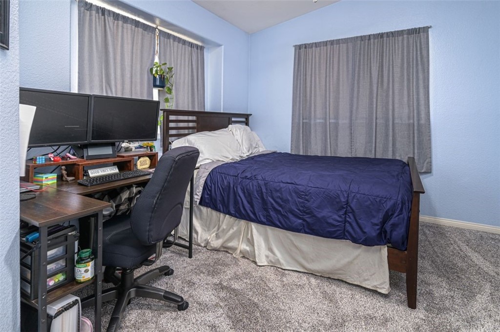 33915 Pinehurst Drive Yucaipa, CA 92399 - Photo 21 of 33 a bedroom with a bed and a computer on a desk