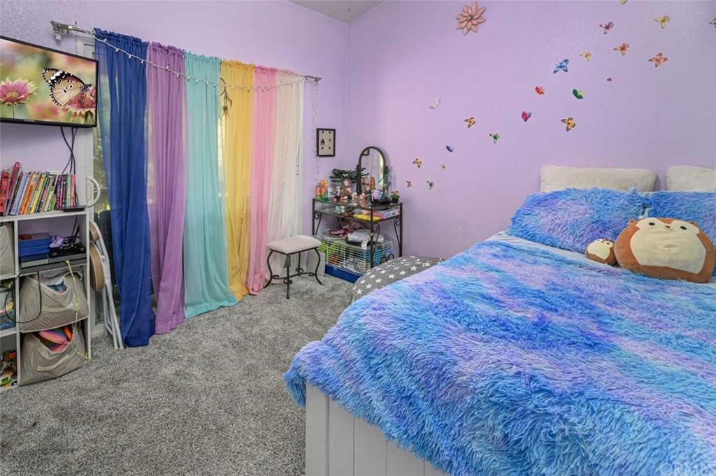 33915 Pinehurst Drive Yucaipa, CA 92399 - Photo 23 of 33 a bed room with a bed and a television