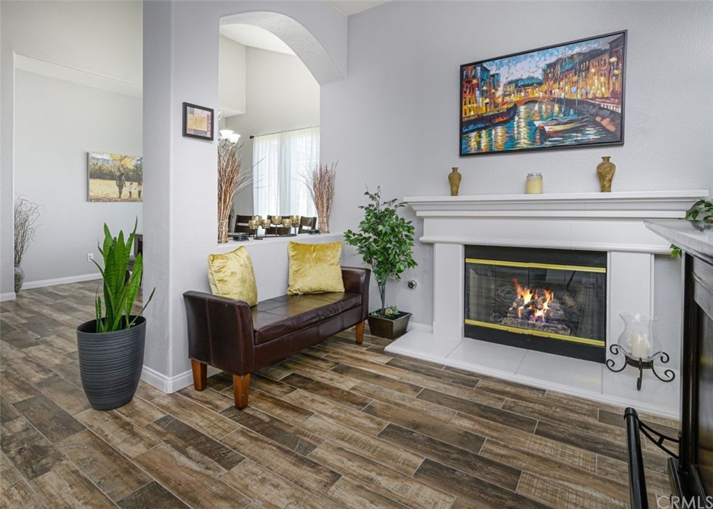33915 Pinehurst Drive Yucaipa, CA 92399 - Photo 4 of 33 a living room with furniture a fireplace and a potted plant