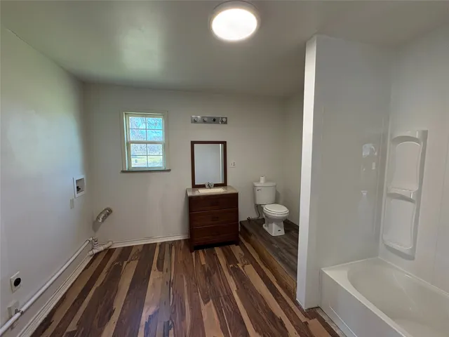 a bathroom with a sink mirror and a bathtub