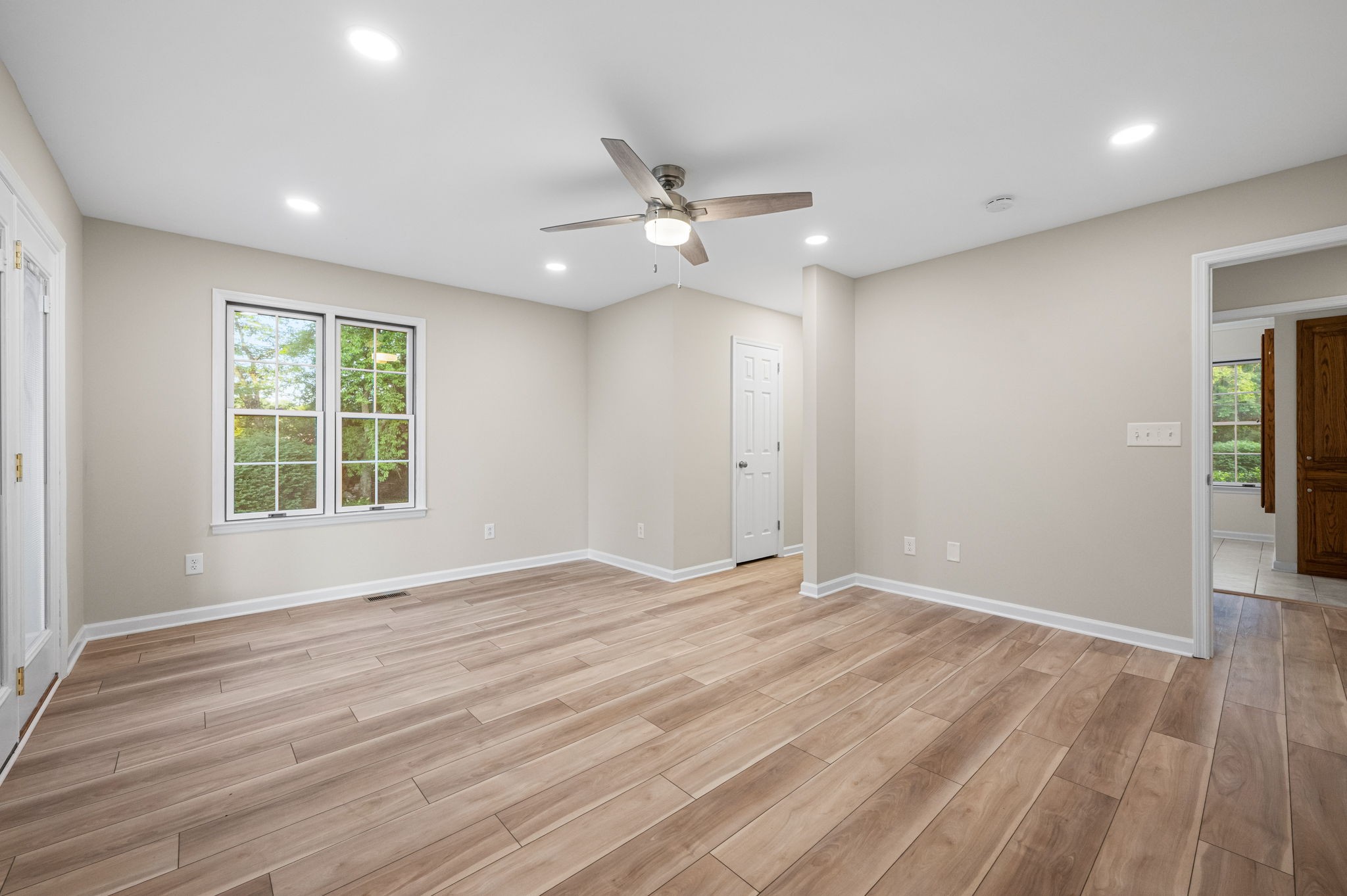 205 Normandy Road Wartrace, TN 37183 - Photo 30 of 70 an empty room with wooden floor ceiling fan and windows