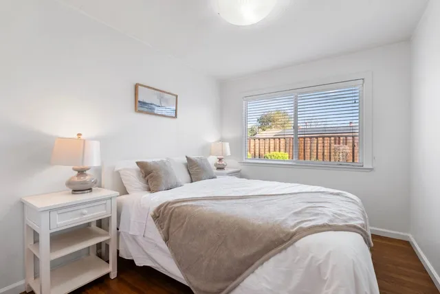 a bedroom with a bed and a night stand