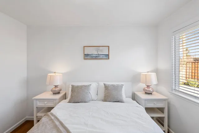 a bedroom with a bed and window