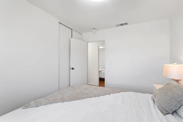 a bedroom with a bed and a toilet