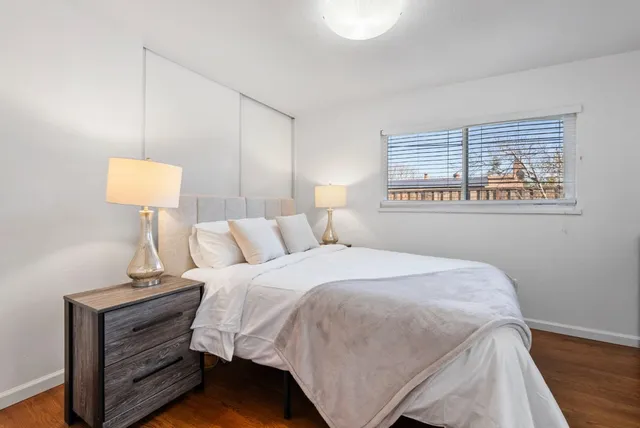 a bedroom with a bed and a night stand