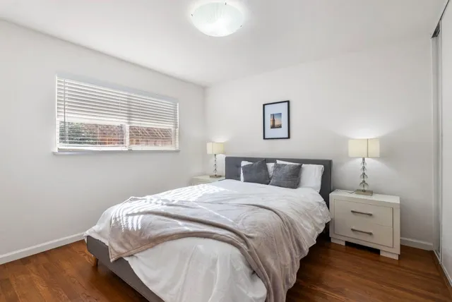 a bedroom with a bed and a night stand