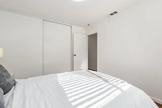 a bedroom with a bed and a shower