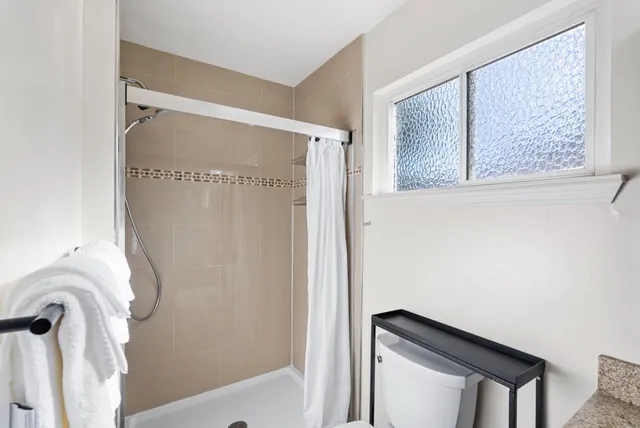 a bathroom with a bathtub and a shower