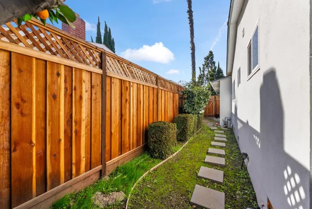 a view of a backyard with pathway