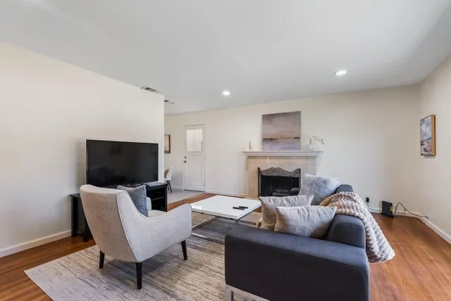 a living room with furniture and a fireplace