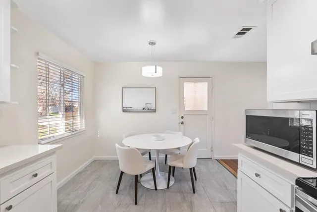 a view of a dining room with furniture and a fireplace
