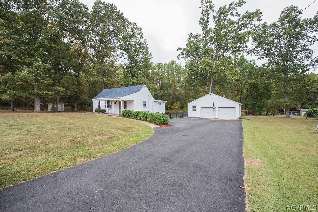 a front view of a house with a yard and trees