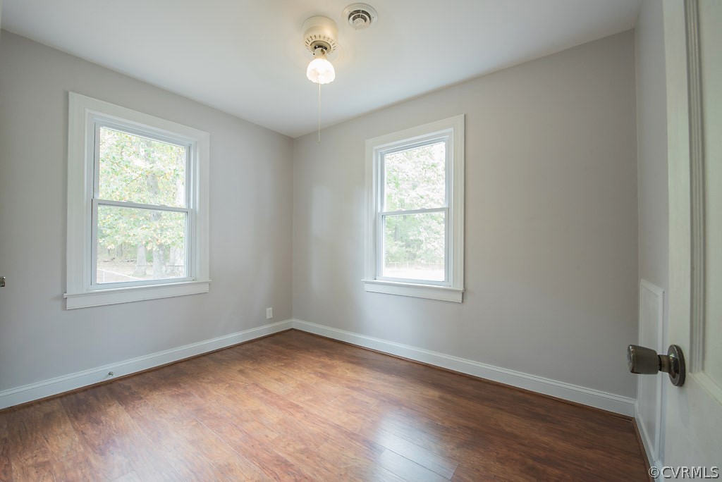 534 Old Bermuda Hundred Road Chester, VA 23836 - Photo 13 of 38 an empty room with wooden floor and windows