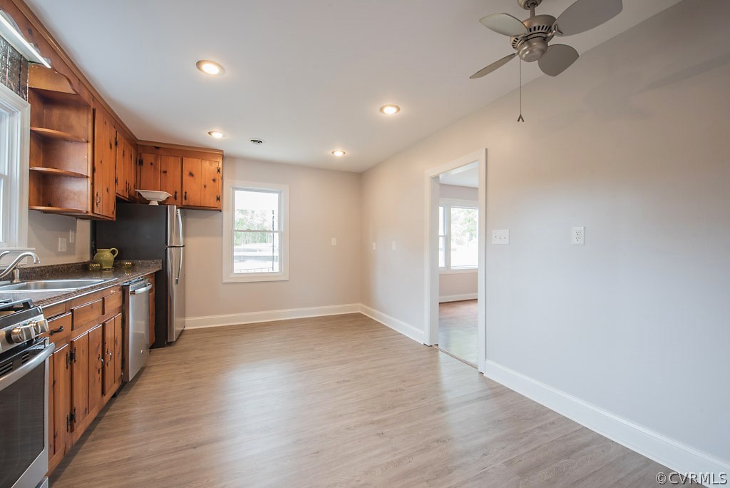 534 Old Bermuda Hundred Road Chester, VA 23836 - Photo 18 of 38 an empty room with wooden floor and a kitchen