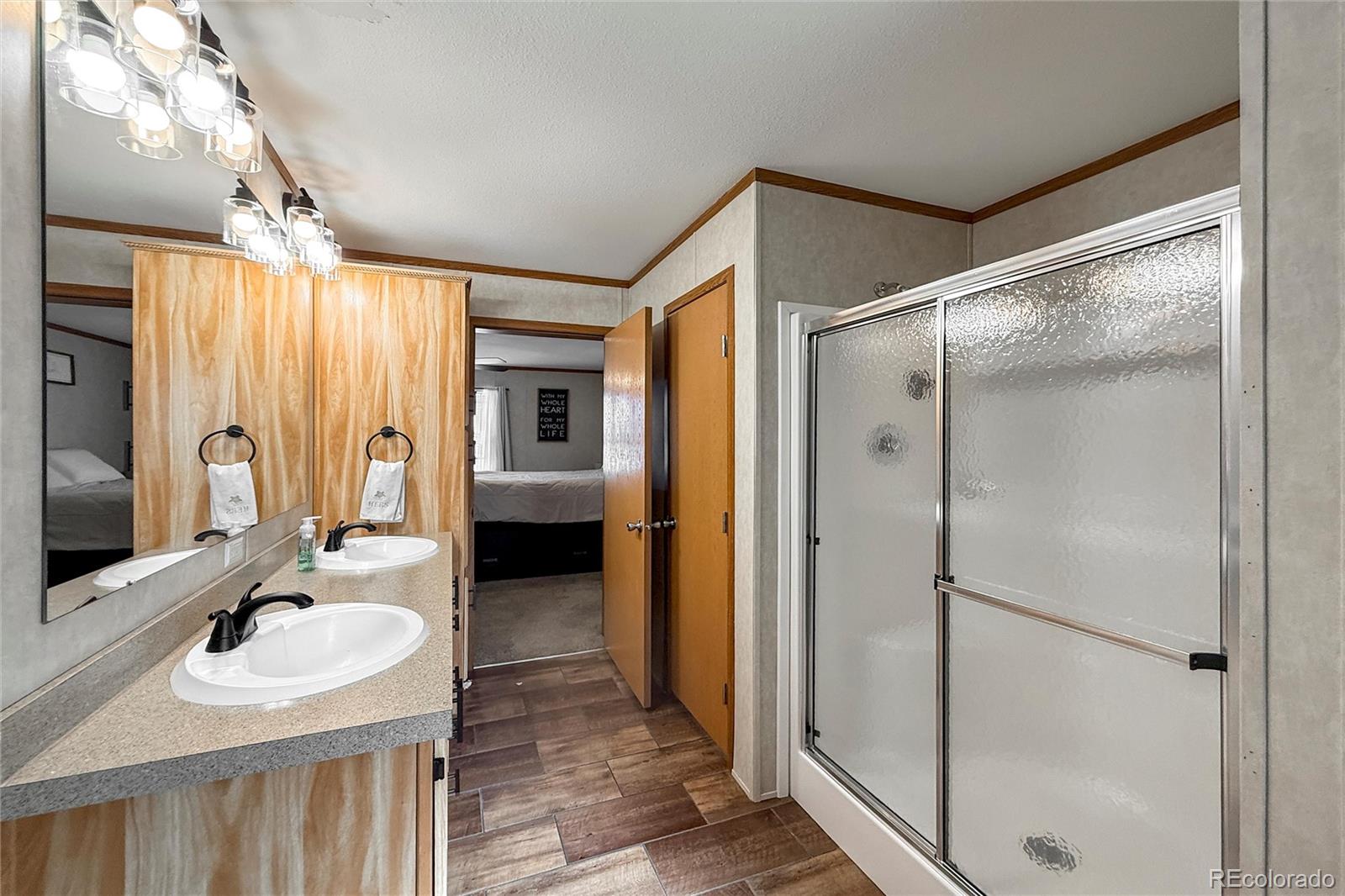 16412 Higgins Avenue Fort Lupton, CO 80621 - Photo 15 of 27 a bathroom with a double vanity sink mirror and shower