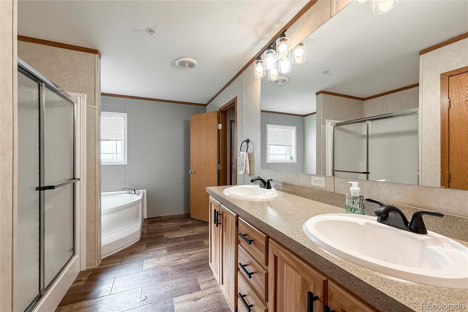 16412 Higgins Avenue Fort Lupton, CO 80621 - Photo 16 of 27 a bathroom with a double vanity sink mirror and bathtub