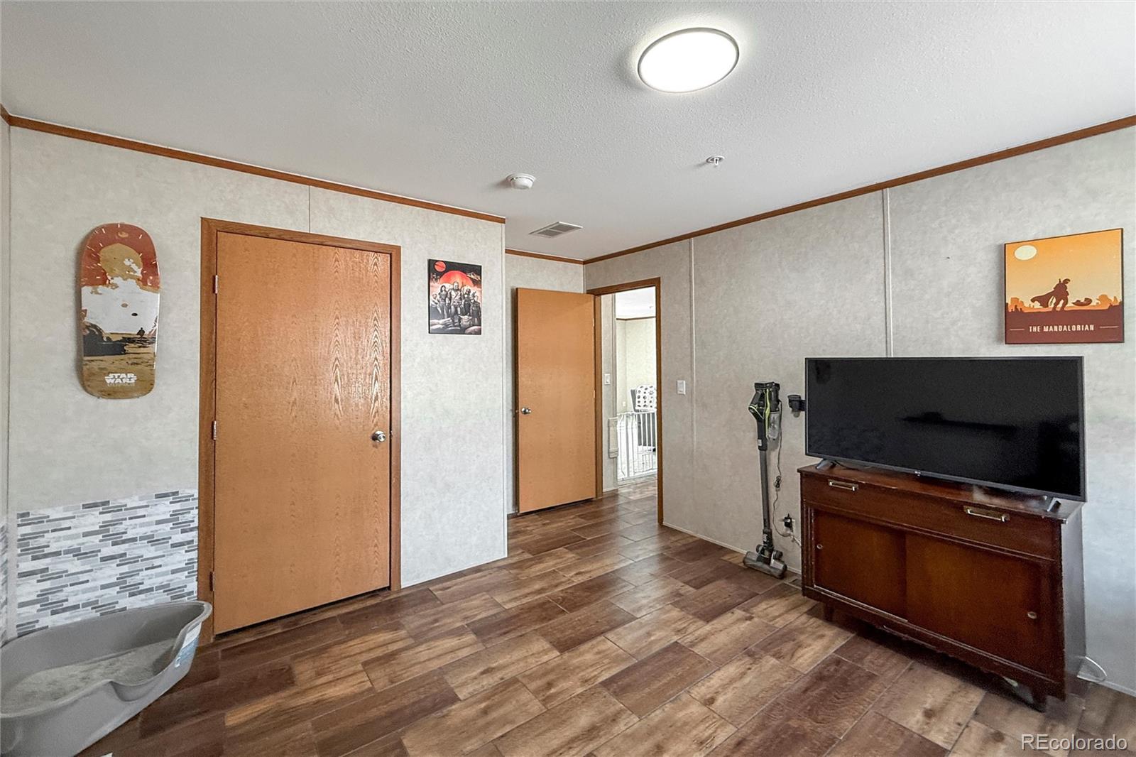 16412 Higgins Avenue Fort Lupton, CO 80621 - Photo 20 of 27 a living room with furniture and a flat screen tv