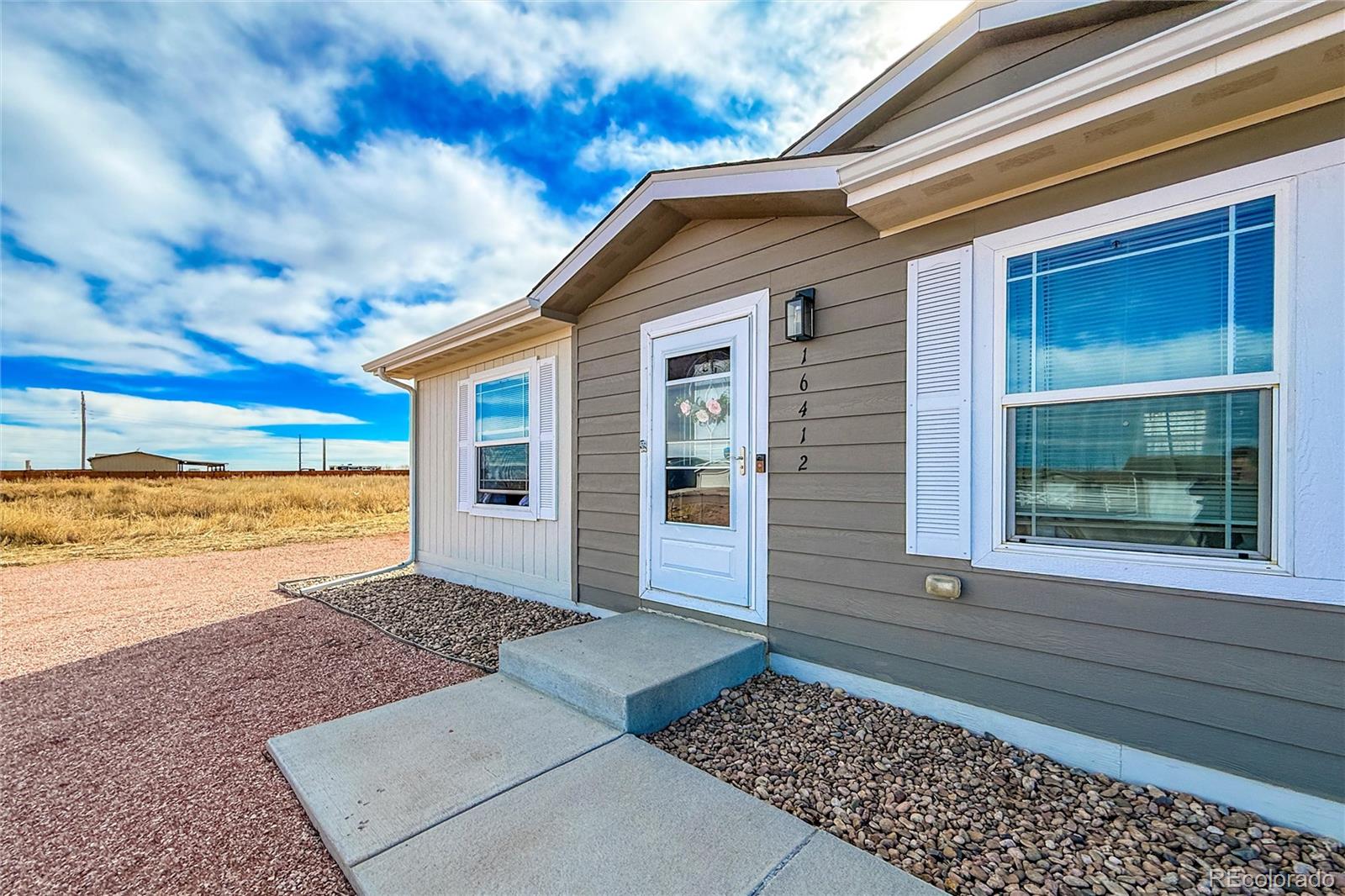 16412 Higgins Avenue Fort Lupton, CO 80621 - Photo 2 of 27 a view of a house with a yard