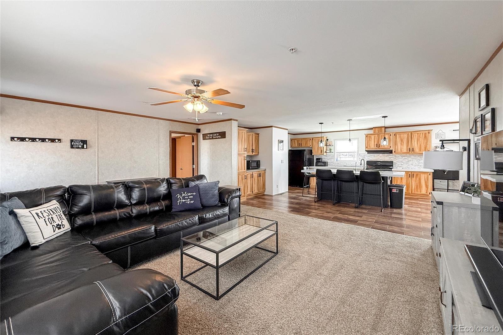 16412 Higgins Avenue Fort Lupton, CO 80621 - Photo 4 of 27 a living room with furniture and kitchen view