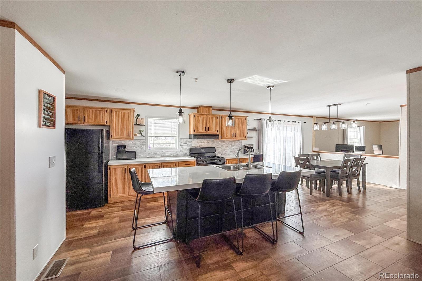 16412 Higgins Avenue Fort Lupton, CO 80621 - Photo 5 of 27 a dining room with furniture and window