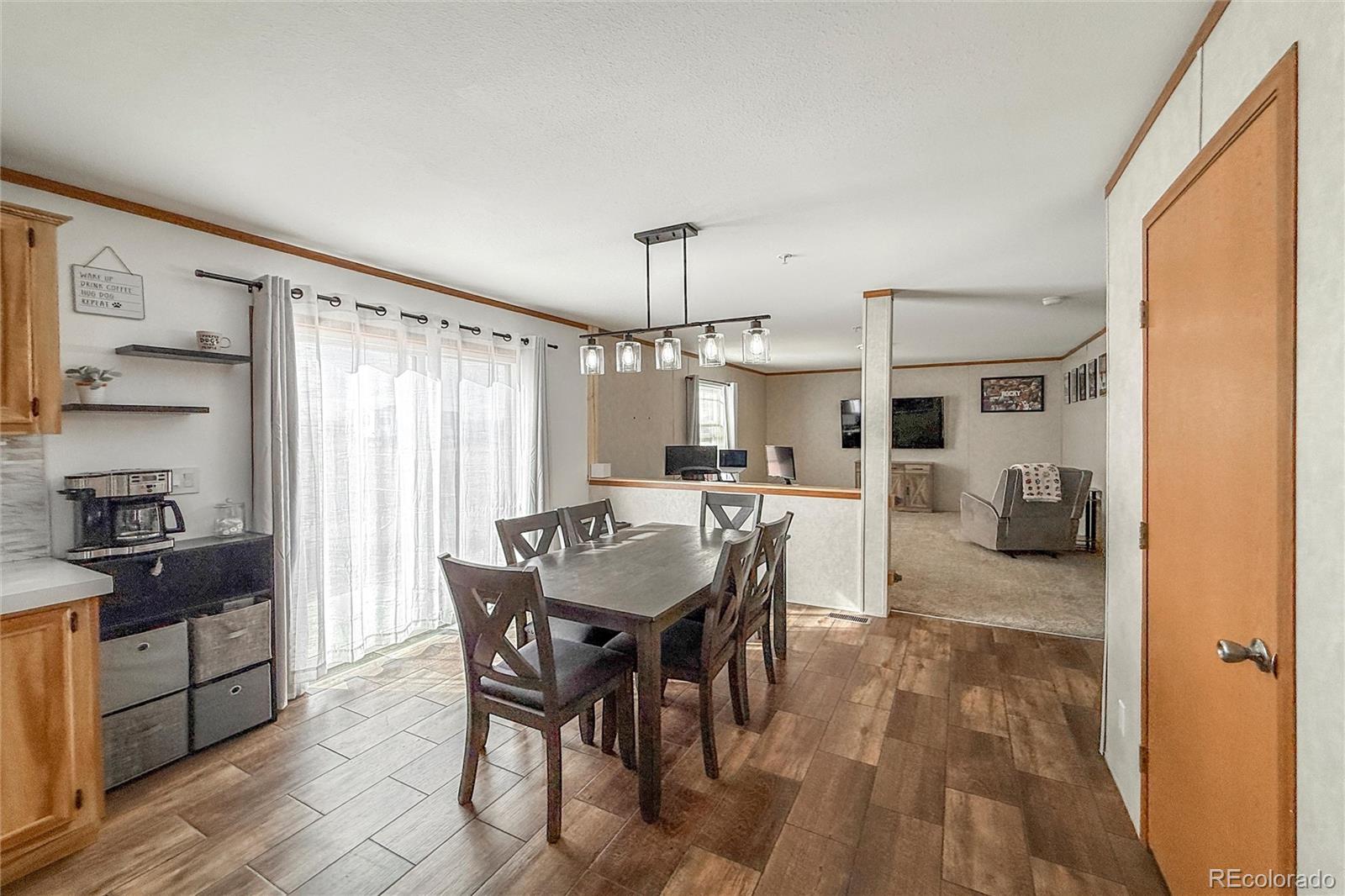 16412 Higgins Avenue Fort Lupton, CO 80621 - Photo 8 of 27 a view of a dining room with furniture window and wooden floor