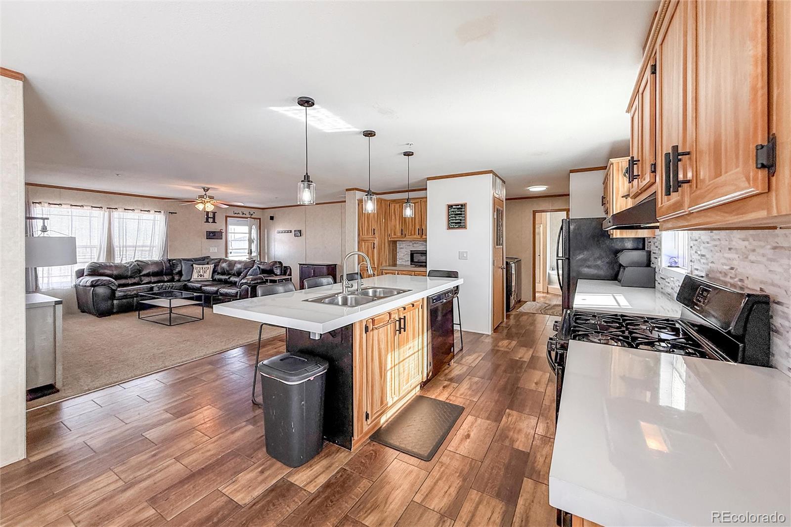 16412 Higgins Avenue Fort Lupton, CO 80621 - Photo 9 of 27 a kitchen with lots of counter top space and a sink