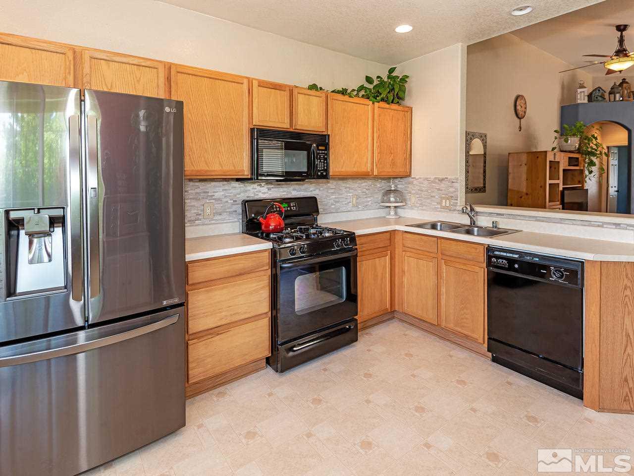 2135 Evergreen Reno, NV 89521 - Photo 8 of 20 a kitchen with stainless steel appliances granite countertop a refrigerator stove and sink