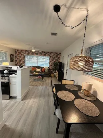 a dining room with furniture and wooden floor