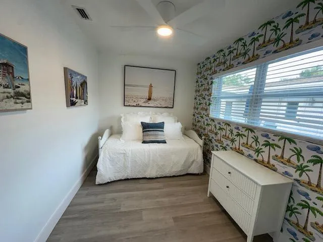 a bedroom with a bed and a window