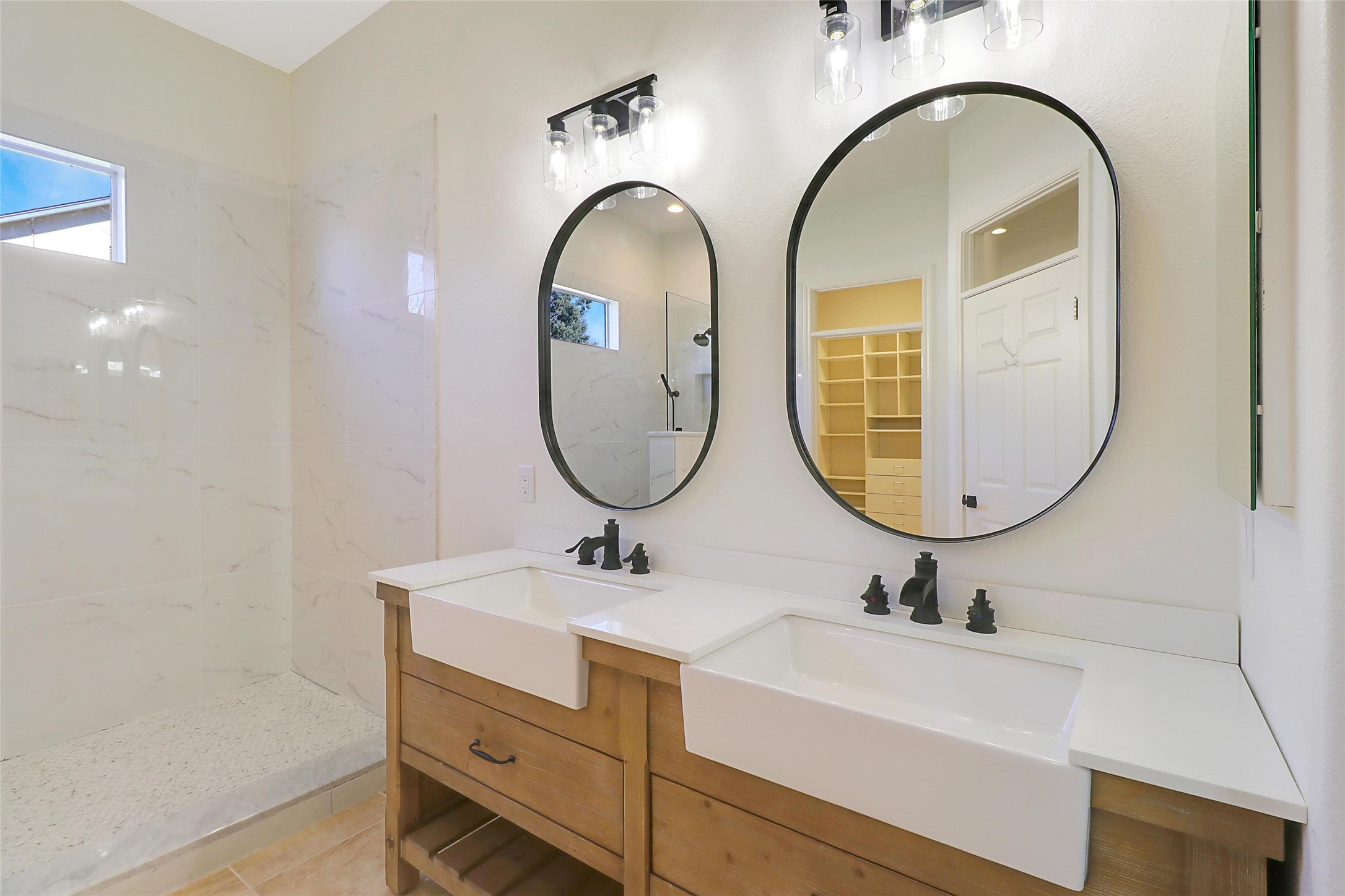 109 Sunflower Street Georgetown, TX 78633 - Photo 12 of 19 Primary bathroom with farm style dual vanity.